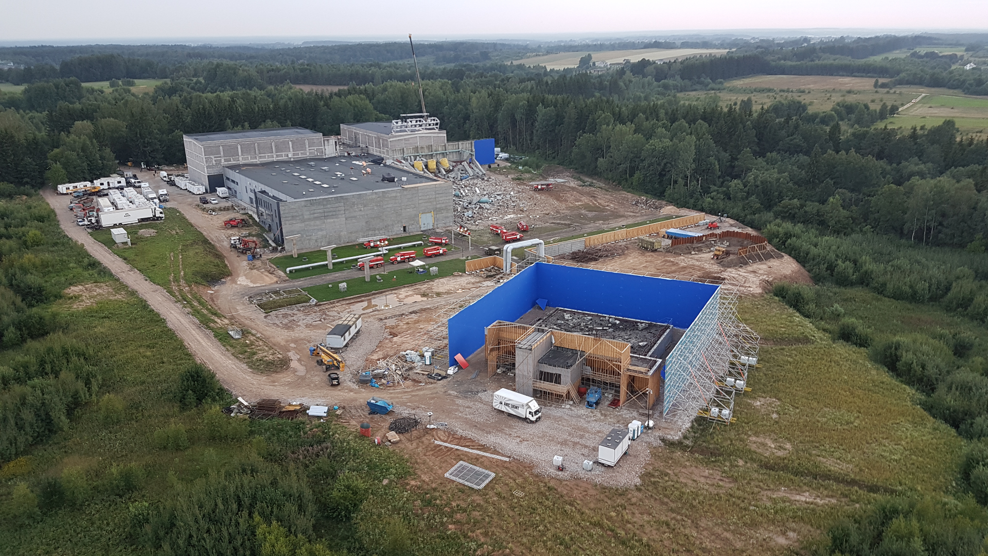 Aerial view of the KinoStudija backlot with large blue screen, sound stages and set construction