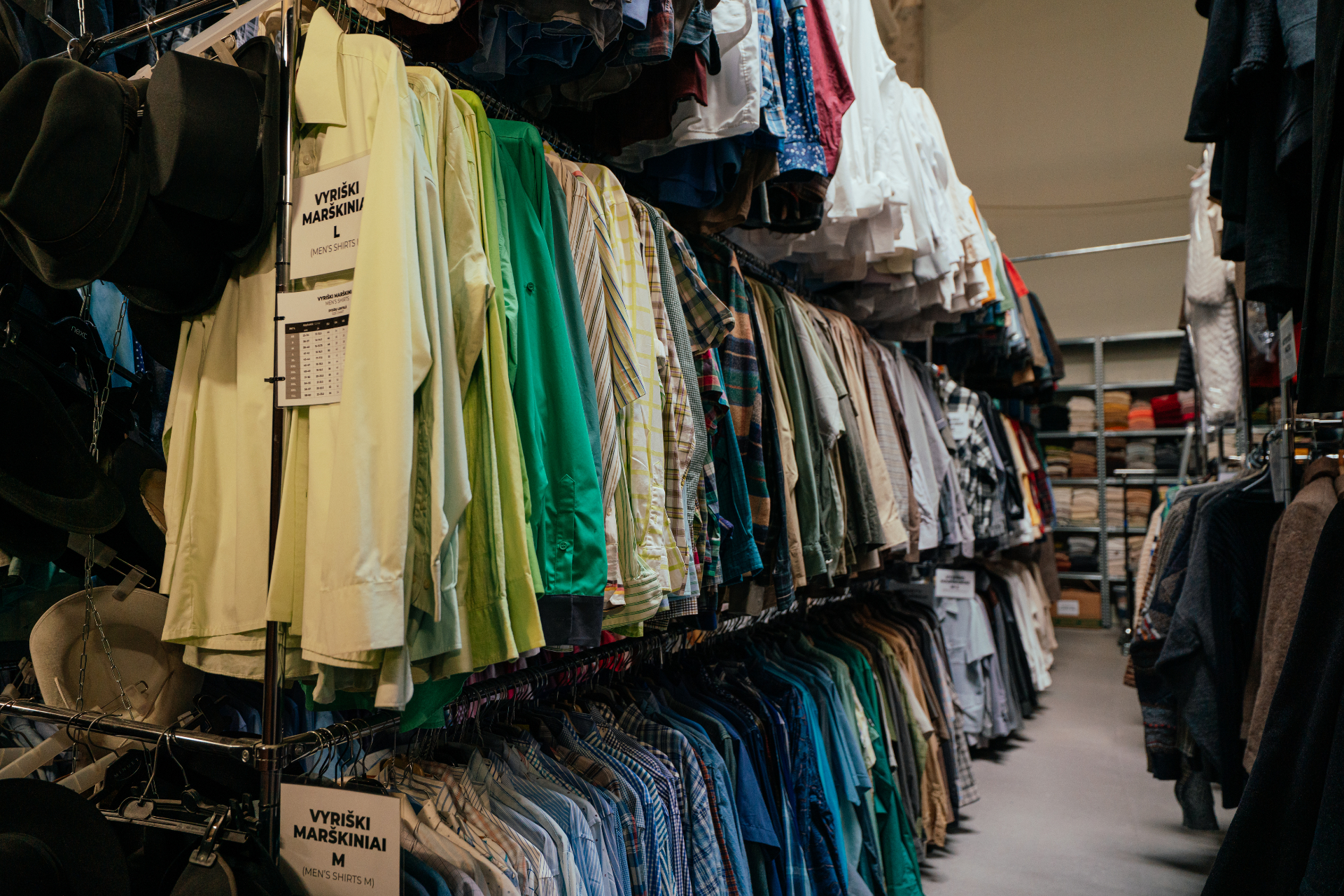 Costume rental rack with organized garments and hats