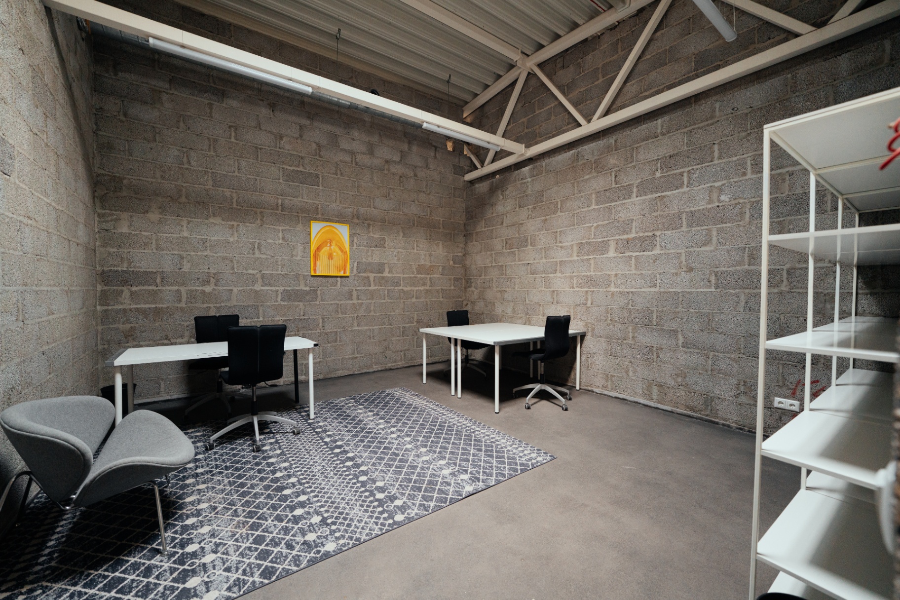 Second floor production office with desks and shelves